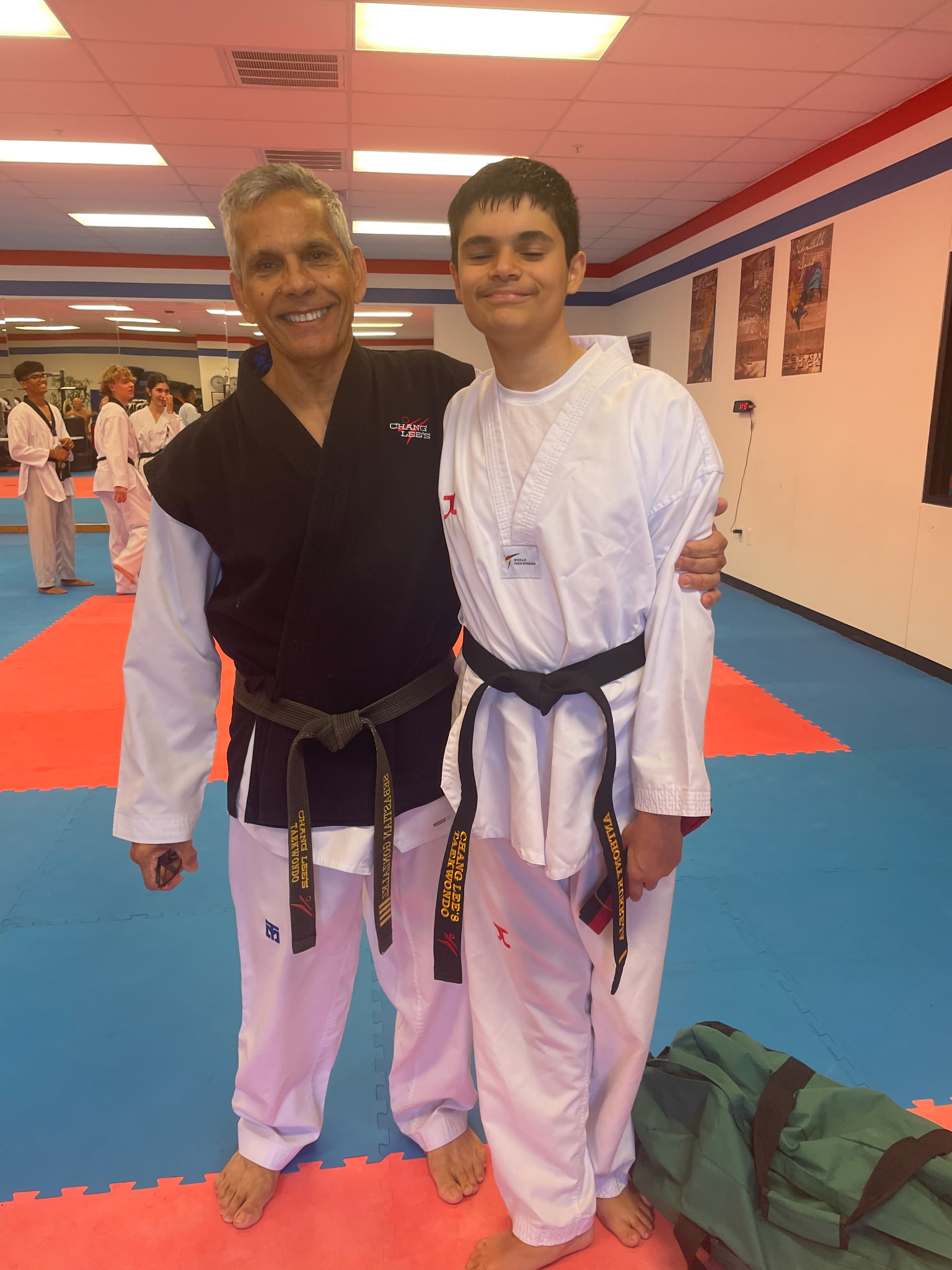 Master Sebastian Gonzalez with a teenage student who has earned his black belt at Chang Lee's Taekwondo in Allen, TX