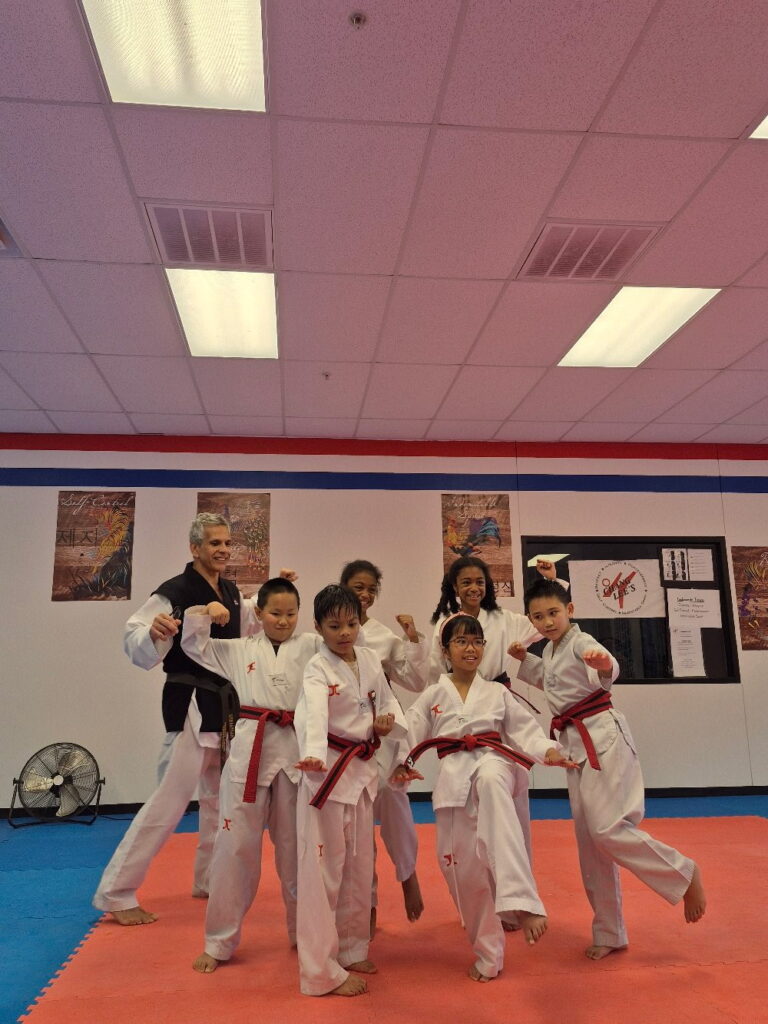 Master Gonzalez with his red belt students during a kids Taekwondo class in Allen, TX