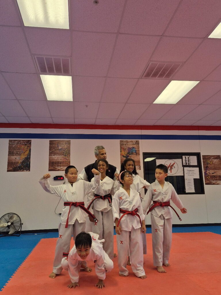 Master Gonzalez standing with his red belt students at Chang Lee's Taekwondo in Allen, TX